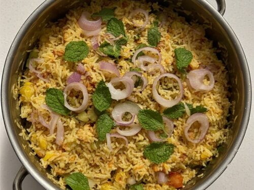 A colorful pot of Vegetable Biryani with long grains of rice and vibrant vegetables